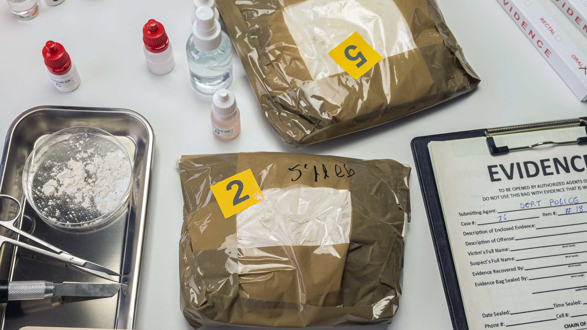 drugs laid out on a table with evidence notes